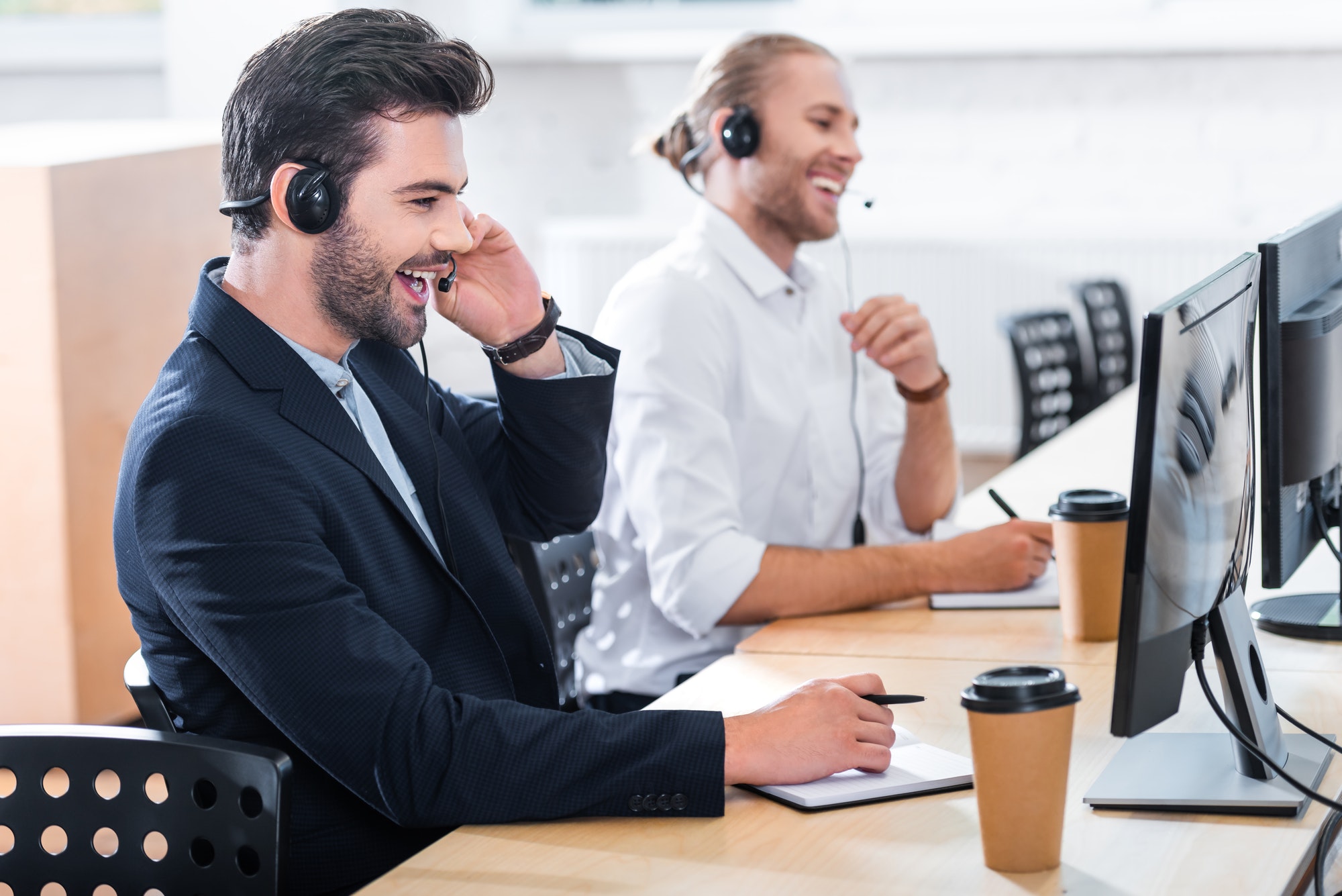 side-view-of-male-call-center-operators-in-headsets-at-workplace-in-office.jpg side-view-of-male-call-center-operators-in-headsets-at-workplace-in-office.jpg